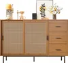 A wooden sideboard with cane doors and drawers, decorated with a coffee machine, a pour-over coffee set, a framed picture, and a vase of flowers. Voir les images du produit