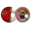 A product shot of two round containers, one open showing red glittery material, the other closed with a cartoon monster graphic. Podgląd zdjęcia produktu