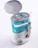 A white and blue water flosser with its lid open, revealing multiple cleaning tips stored inside. The device is placed on a white background. Produktbild-Vorschau