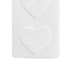A close-up of a white ceramic radiator humidifier with embossed heart designs. Voir les images du produit