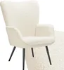 A cream-colored, fluffy armchair with black legs against a white background. Náhled obrázku produktu