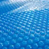 A close-up, abstract view of a blue solar pool cover with a pattern of raised bubbles. Anteprima dell’immagine prodotto