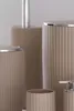 A collection of bathroom accessories, including a soap dispenser, a cup, and a trash can, are arranged on a plain background. Produktbild-Vorschau