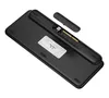 The underside of a black keyboard is shown, with a USB dongle and its storage compartment visible. Produktbild-Vorschau