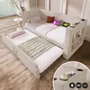 A daybed with a pull-out trundle bed, set up in a room with a wooden floor and a window with blinds. Anteprima dell’immagine prodotto