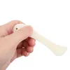 A hand holding a white plastic creasing tool. Produktbild-Vorschau