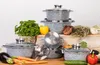 A set of cookware with various vegetables and decorative elements. Produktbild-Vorschau