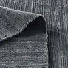 Close-up view of a folded gray rug, showing its texture and weave. Produktbild-Vorschau