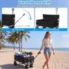 A woman is walking on a beach with a folded wagon filled with items. Produktbild-Vorschau
