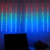 A string of LED lights hangs vertically against a blue wall, with a laptop in the foreground. Produktbild-Vorschau