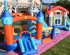 An inflatable castle bounce house set up on a pink tarp on a grassy lawn in front of a house. Náhled obrázku produktu