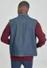 A person wearing a denim vest over a burgundy long-sleeved shirt. Produktbild-Vorschau