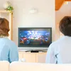 Two people are watching TV in a living room. Voir les images du produit