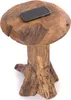 A wooden stool with a mushroom-like top and a rough-hewn base, with a smartphone placed on top. Náhľad obrázku produktu