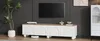 A modern living room scene featuring a TV stand with a TV mounted above it, a plant, and decorative items. Voir les images du produit
