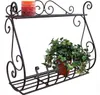 A black metal wall shelf with a candle and a potted plant. Náhľad obrázku produktu