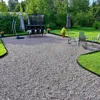A backyard patio with gravel, grass, outdoor furniture, and a trampoline. Voir les images du produit