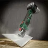 A cordless rotary cutter is shown cutting a tile, with dust flying off. Produktbild-Vorschau