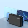 A black power bank is placed in front of a blue smartphone, with large '15W' text in the background. Produktbild-Vorschau