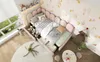 A child's bedroom with a pink upholstered bed, toys, and decorative elements. Podgląd zdjęcia produktu