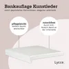 A white cushion on a light pink background with text overlays describing its features. Produktbild-Vorschau