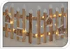 A wooden fence decorated with small birdhouses and fairy lights. Náhled obrázku produktu
