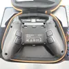 The back of a black gaming controller is shown inside its open case. Podgląd zdjęcia produktu