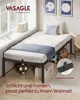A bedroom scene with a single bed, pillows, and decorative items. Produktbild-Vorschau