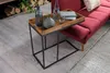 A side table with a tray on it, placed next to a red sofa. Produktbild-Vorschau