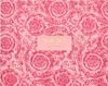 A pink patterned box with the Versace logo and product name. Anteprima dell’immagine prodotto