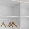A close-up view of a white wardrobe interior with a hanging rail and wooden hangers. Produktbild-Vorschau