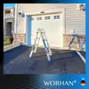 A silver and blue multi-purpose ladder is set up in front of a closed garage door on a paved driveway. Náhľad obrázku produktu