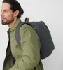A man wearing a green jacket and a backpack. Náhled obrázku produktu
