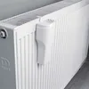 A close-up shot of a white radiator with a white humidifier attached. Náhľad obrázku produktu