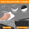 Close-up shots of a grey absorbent pad demonstrating its features like absorbency, leak-proofing, breathability, and anti-slip properties. A hand is shown wiping up liquid with a white cloth. Produktbild-Vorschau