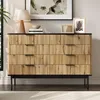 A dresser with a wood-grain finish and black top and legs, decorated with framed art and a lamp. Produktbild-Vorschau