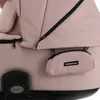 A close-up view of a pink baby stroller with black accents. Produktbild-Vorschau