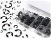 A set of E-clips or circlips in a clear plastic organizer box, with loose clips scattered around the white background. Produktbild-Vorschau