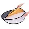 Hands holding a collapsible photography reflector with gold and white sides. Podgląd zdjęcia produktu