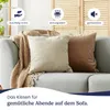 Two decorative pillows on a sofa with a blanket. Produktbild-Vorschau