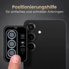 A finger is shown holding a camera lens protector template over a smartphone's camera array. Produktbild-Vorschau