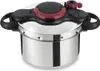 A stainless steel pressure cooker with a black and red lid and handles, shown from a slightly elevated front-side angle on a white background. Podgląd zdjęcia produktu