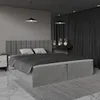 A modern bedroom with a large grey bed. Náhled obrázku produktu
