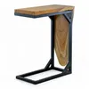 A C-frame side table with a teak wood top and a wooden panel on the side, presented against a white background. Voir les images du produit