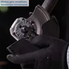A gloved hand is shown adjusting a protective guard on a power tool. Produktbild-Vorschau