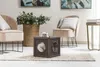 A cat is sitting inside a pet cube in a living room setting with chairs and decor. Podgląd zdjęcia produktu