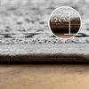 A close-up view of the edge of a rug, showing its thickness and texture. A circular overlay indicates the thickness as 1.2 cm. Produktbild-Vorschau