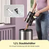 A person is emptying a cordless vacuum cleaner into a trash can, with an inset showing the vacuum's dustbin being washed. Produktbild-Vorschau