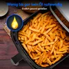 A close-up of an air fryer basket filled with french fries, with text overlays highlighting features. Produktbild-Vorschau