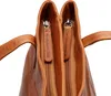 Close-up view of the interior of a brown leather handbag, showing two zippers. Produktbild-Vorschau